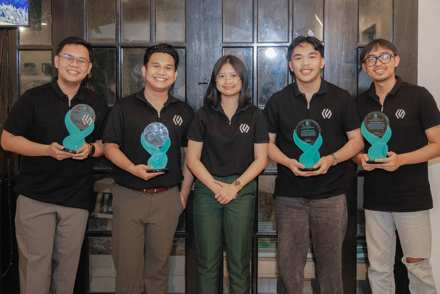 Cerena Solutions team members holding recognition awards during a company celebration