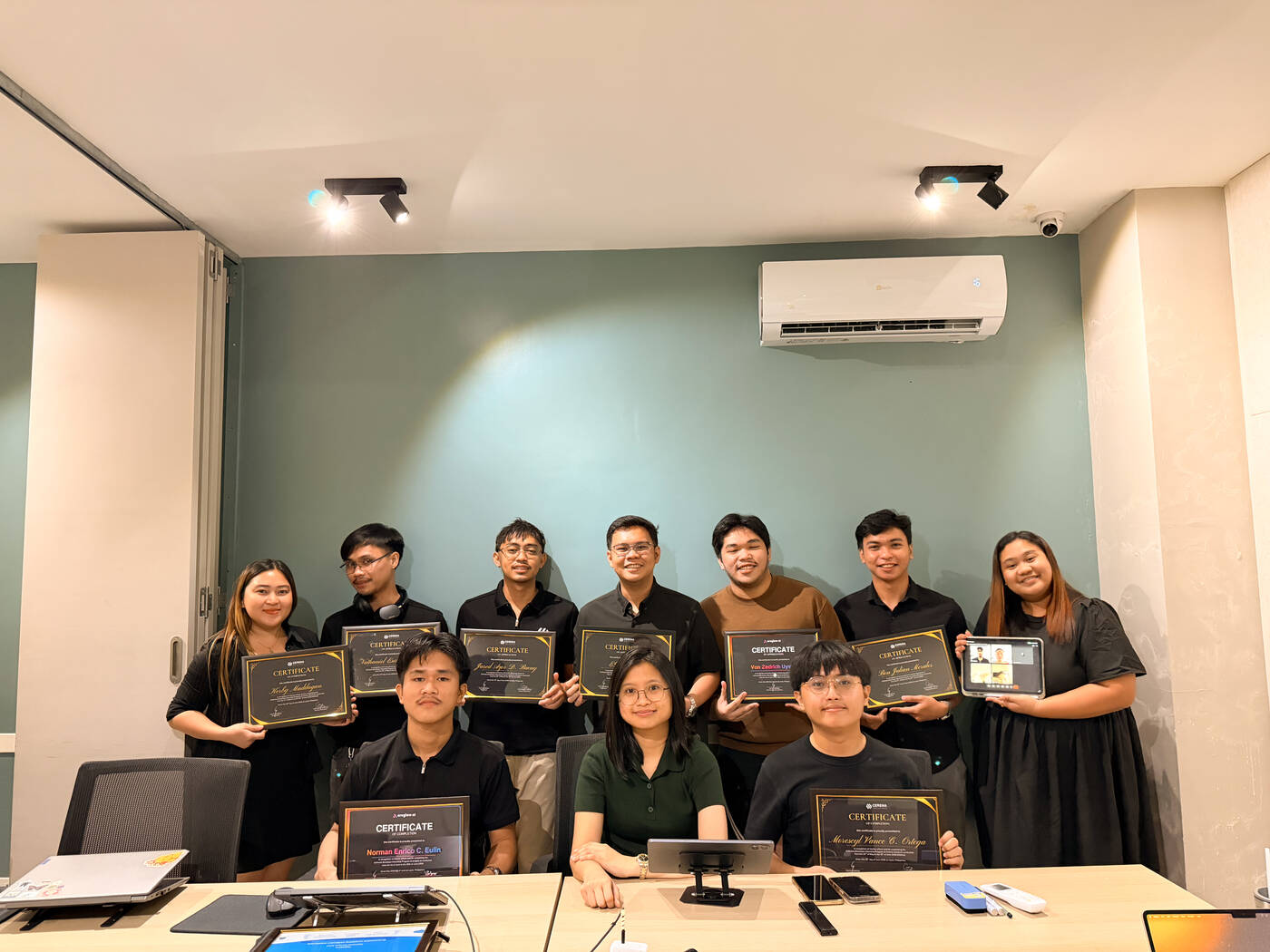 The internship cohort celebrating graduation with the team