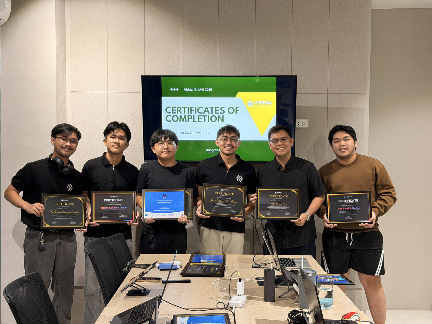 Interns holding their certificates of completion